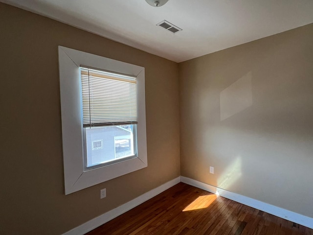 empty room with dark wood-type flooring