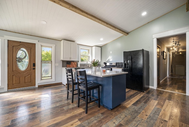 kitchen featuring stainless steel appliances, a center island, lofted ceiling with beams, dark hardwood / wood-style floors, and white cabinetry