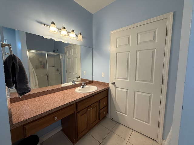 bathroom featuring tile patterned floors, an enclosed shower, and vanity