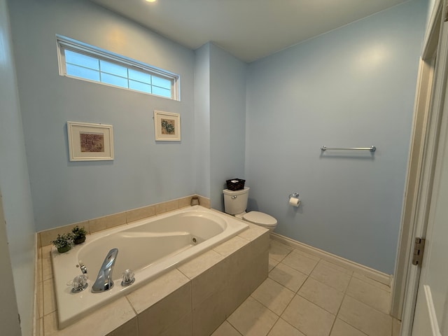 bathroom featuring toilet, tile patterned floors, and tiled tub