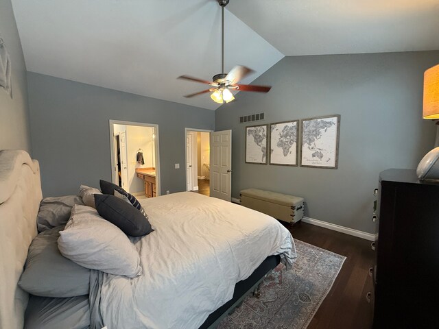 bedroom with ceiling fan, ensuite bath, dark hardwood / wood-style flooring, and lofted ceiling