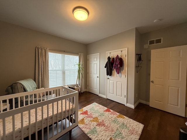 bedroom with a closet and dark hardwood / wood-style flooring