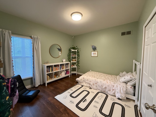 bedroom with dark hardwood / wood-style floors