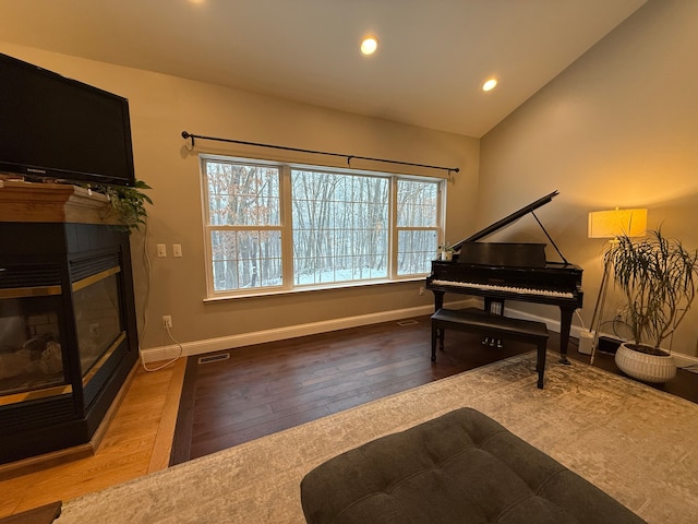 sitting room featuring lofted ceiling and hardwood / wood-style flooring