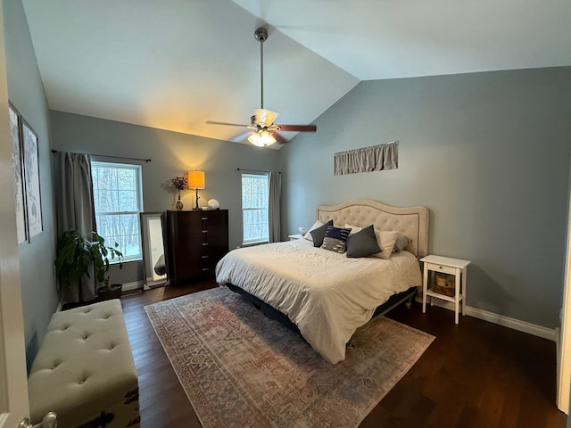 bedroom with ceiling fan, vaulted ceiling, and dark wood-type flooring