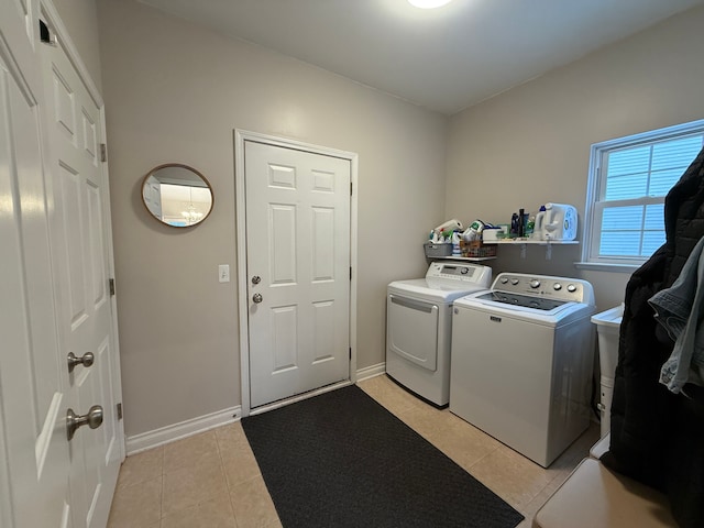 washroom featuring light tile patterned floors and washing machine and dryer