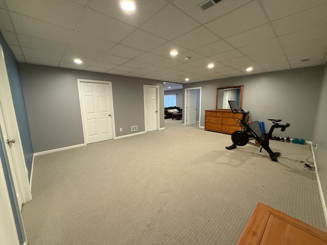 exercise area with a drop ceiling and carpet floors