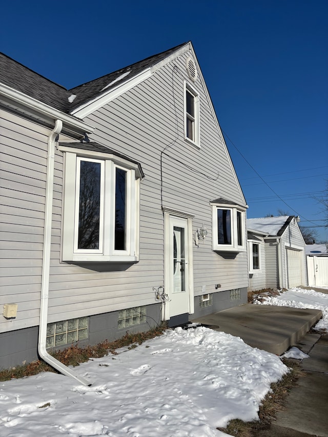 exterior space with a garage and an outbuilding