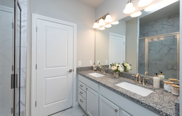 bathroom with vanity and a shower with shower door