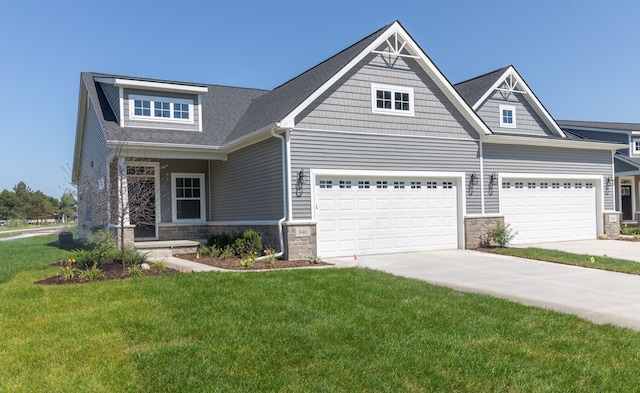 craftsman house featuring a front yard and a garage