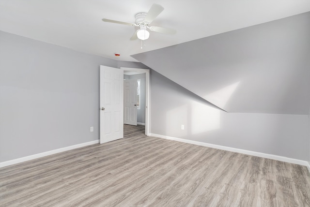 bonus room featuring ceiling fan, vaulted ceiling, and light wood-type flooring