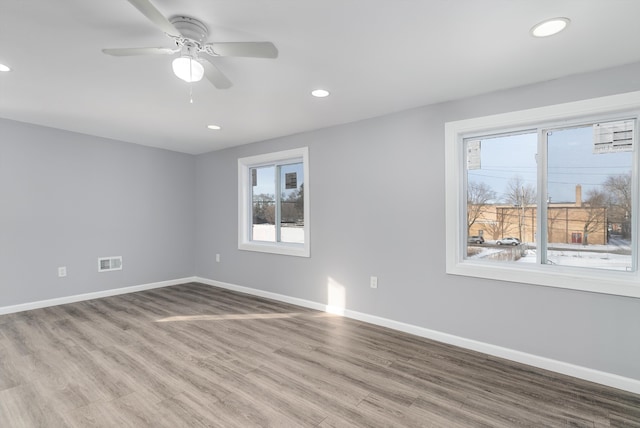 empty room with ceiling fan and light wood-type flooring