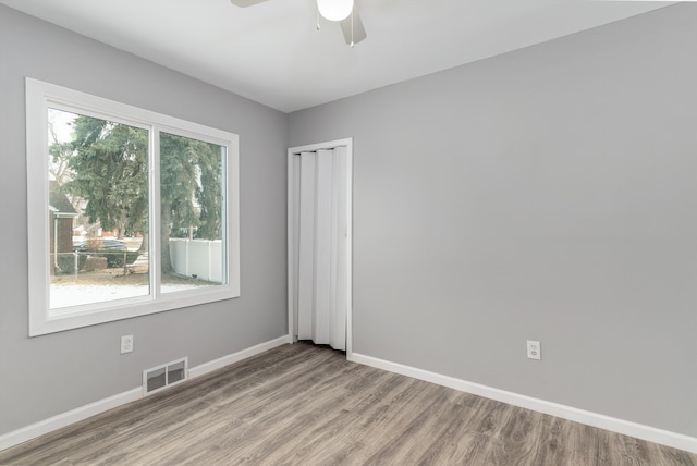 empty room featuring ceiling fan and light hardwood / wood-style floors