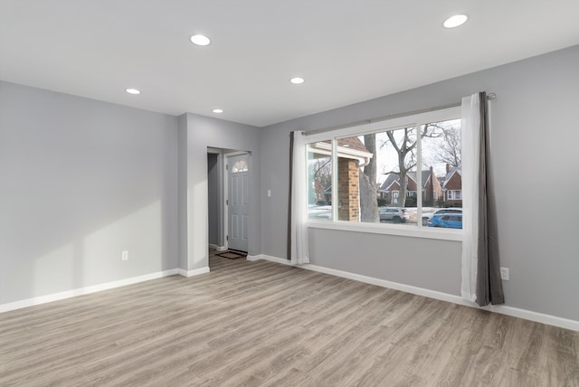 empty room with light hardwood / wood-style flooring