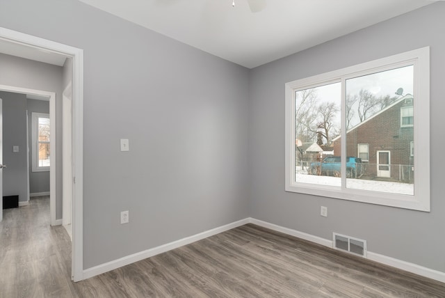 spare room with hardwood / wood-style flooring and ceiling fan