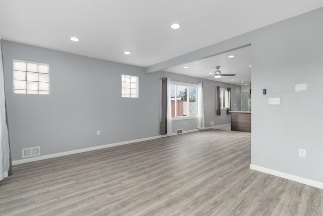 empty room featuring ceiling fan and light hardwood / wood-style flooring