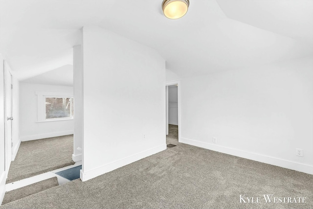 interior space featuring lofted ceiling and carpet floors