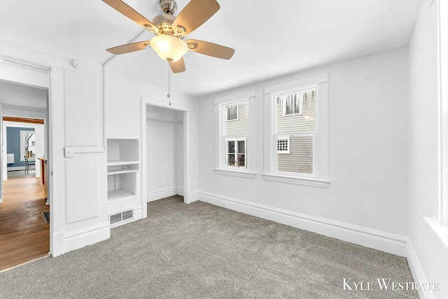 unfurnished bedroom featuring carpet floors, ceiling fan, and a closet