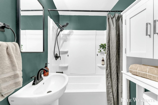 bathroom with sink and shower / bath combo with shower curtain