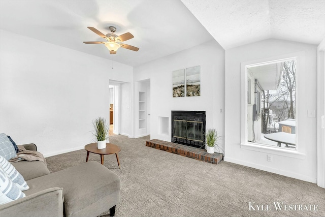 carpeted living room featuring a brick fireplace, a wealth of natural light, a textured ceiling, lofted ceiling, and built in shelves