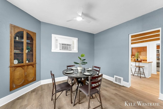 dining area with ceiling fan and wood-type flooring