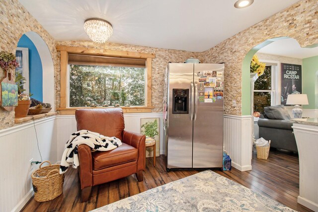 living area featuring a chandelier and hardwood / wood-style floors