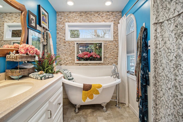 bathroom with vanity and a tub to relax in