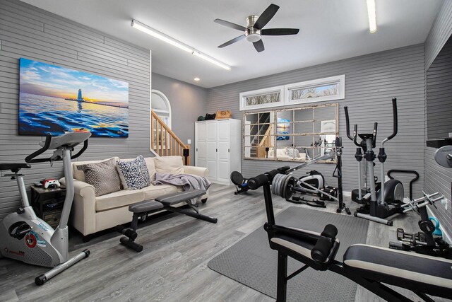 workout area featuring ceiling fan and hardwood / wood-style floors