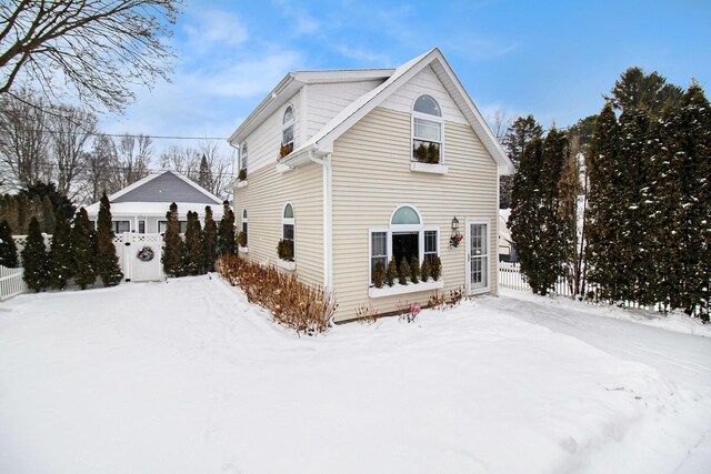 view of snow covered rear of property