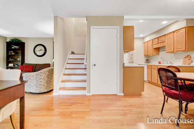 kitchen with light hardwood / wood-style floors, light brown cabinetry, and sink