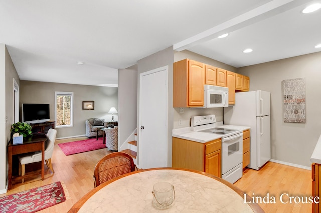 kitchen featuring white appliances, light hardwood / wood-style floors, and light brown cabinets