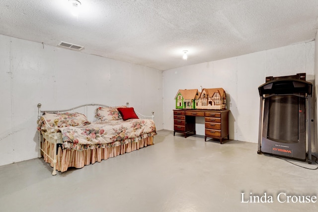 bedroom featuring a textured ceiling and concrete floors