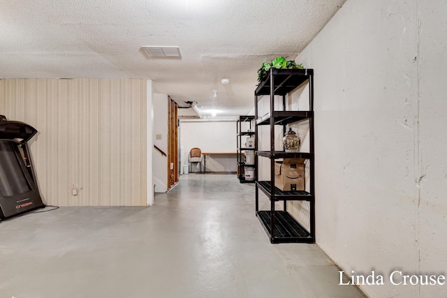 basement featuring a textured ceiling