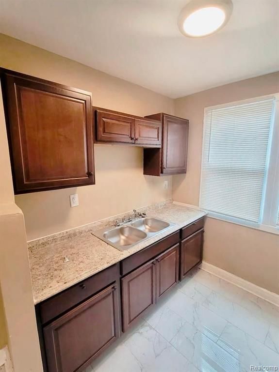 kitchen with sink and dark brown cabinetry