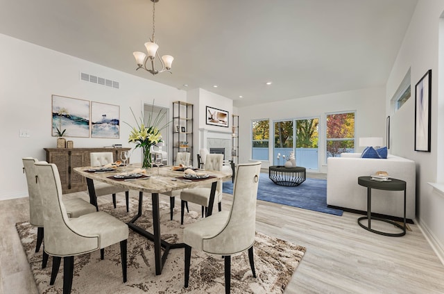 dining area featuring an inviting chandelier and light wood-type flooring