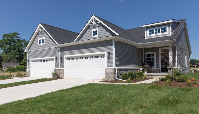 craftsman-style home featuring a front lawn and a garage