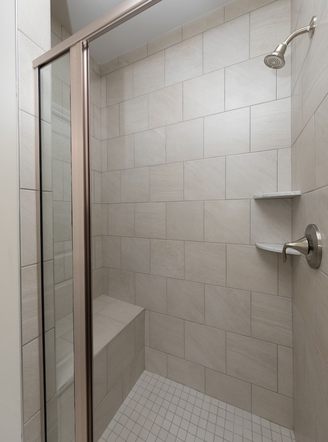 bathroom featuring a shower with door