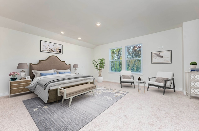 bedroom featuring lofted ceiling and light carpet