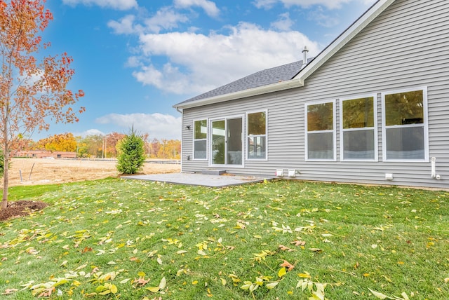 rear view of property with a patio area and a yard