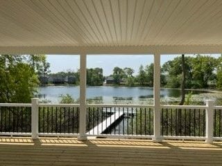 wooden deck featuring a water view