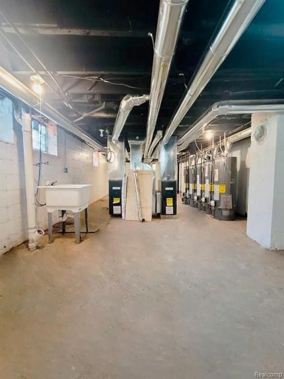 basement featuring sink and water heater