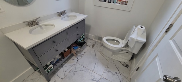 bathroom with visible vents, marble finish floor, baseboards, and a sink