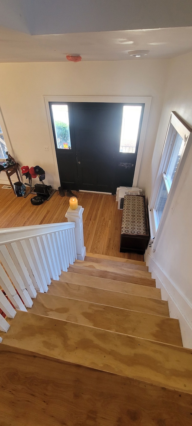 staircase with wood finished floors