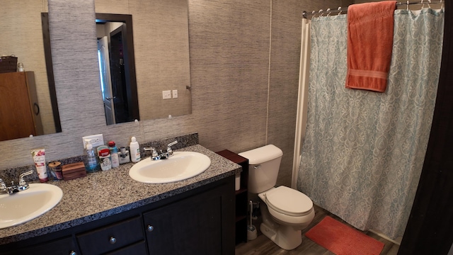 bathroom with toilet, vanity, and a shower with curtain