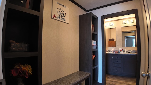 bathroom with hardwood / wood-style floors, crown molding, and built in features