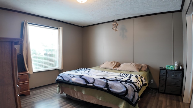 bedroom with ornamental molding, hardwood / wood-style floors, and a textured ceiling