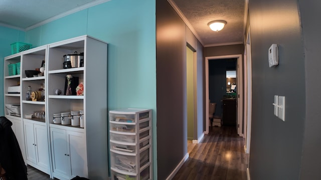 hallway with a textured ceiling, ornamental molding, and dark hardwood / wood-style floors