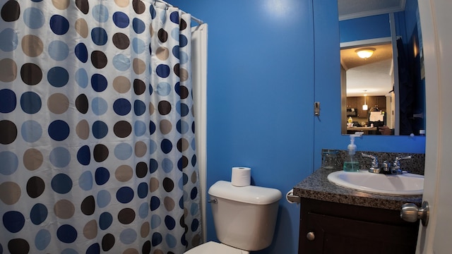 bathroom featuring toilet, curtained shower, ornamental molding, and vanity