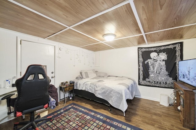 bedroom with wooden ceiling and dark hardwood / wood-style floors