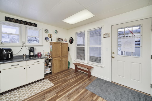 kitchen with dark hardwood / wood-style floors and white cabinetry